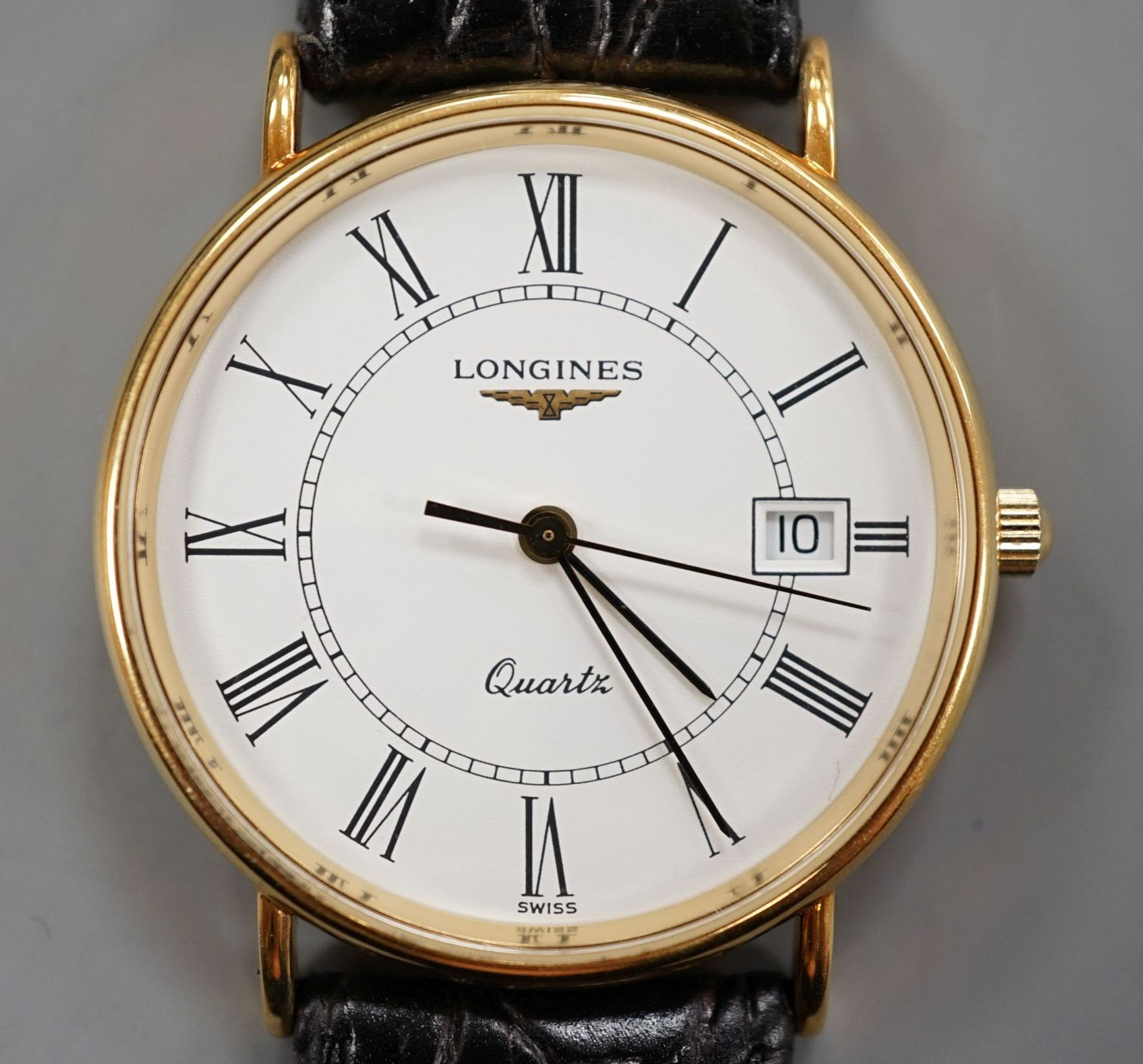 A gentleman's 1999 18ct Longines quartz date wrist watch, with box and papers, case diameter 33mm, gross weight 29.1 grams.